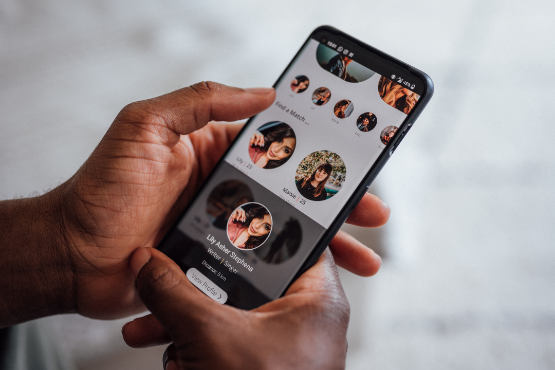 Person browsing a dating app, highlighting the impact of digital interactions on mental wellbeing in online dating.